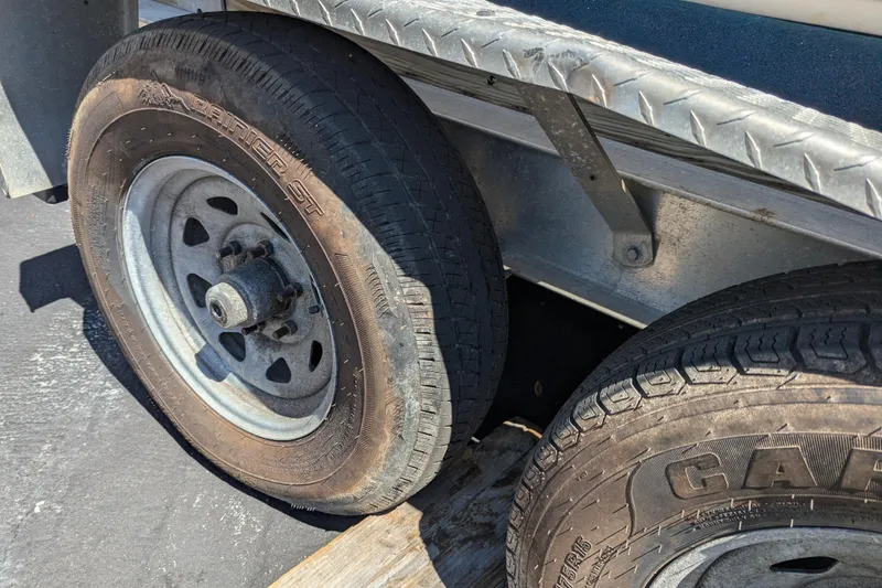 Slide: The Image of Trailer wheels of a 2005 SeaVee 290B boat on a metal frame. - 24