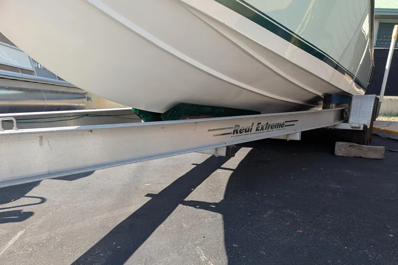 Slide: The Image of 2005 SeaVee 290B boat on Real Extreme trailer, parked on asphalt. - 25