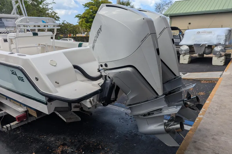 Slide: The Image of 2005 SeaVee 290B boat with dual Mercury Verado outboard engines, parked outdoors. - 27