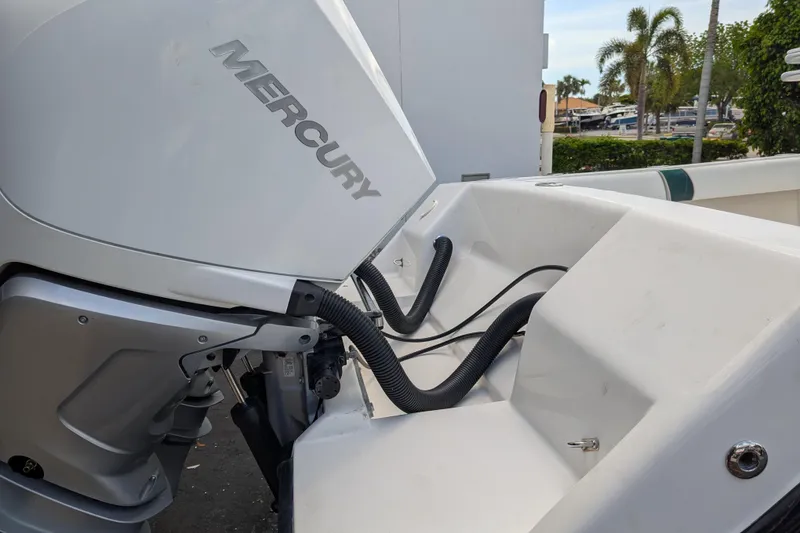 Slide: The Image of 2005 SeaVee 290B boat with Mercury outboard engine, docked near palm trees. - 29