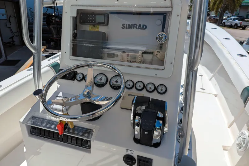Slide: The Image of 2005 SeaVee 290B boat dashboard with Simrad navigation system and steering wheel. - 6