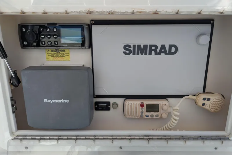 Slide: The Image of Simrad marine display on 2005 SeaVee 290B boat dashboard, reflecting surroundings. - 9
