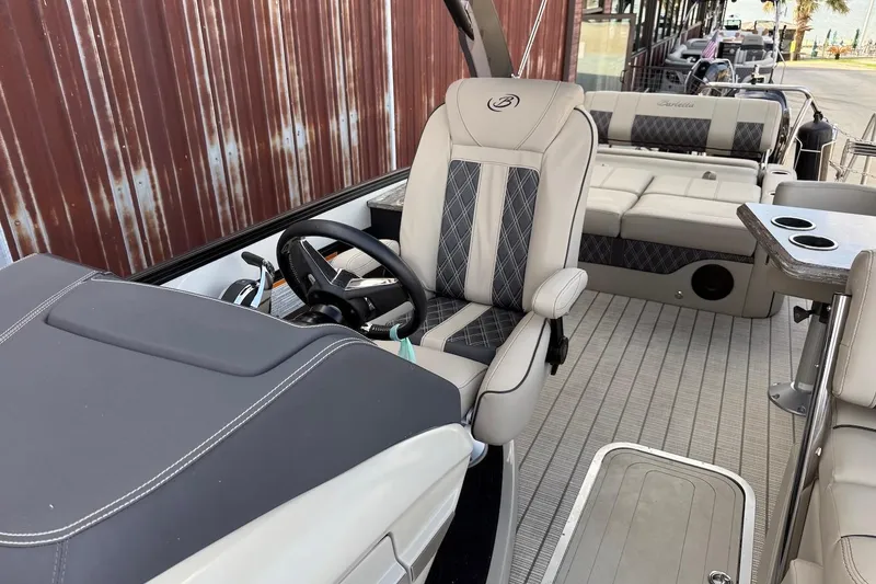 Slide: The Image of 2022 Barletta LUSSO 25UEA boat interior with luxury seating and steering wheel. - 16