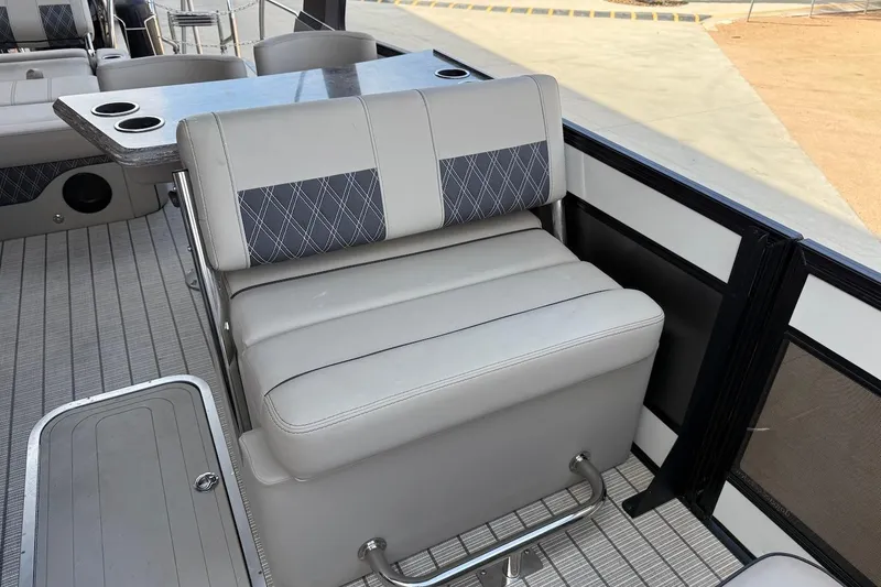 Slide: The Image of 2022 Barletta LUSSO 25UEA boat interior with gray seating and cup holders. - 17