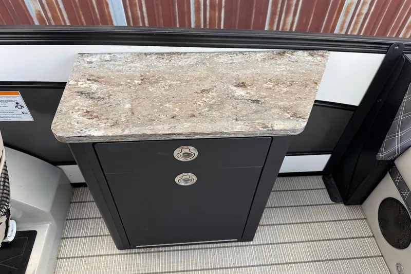 Slide: The Image of Barletta LUSSO 25UEA 2022 boat interior with marble countertop and storage cabinet. - 18