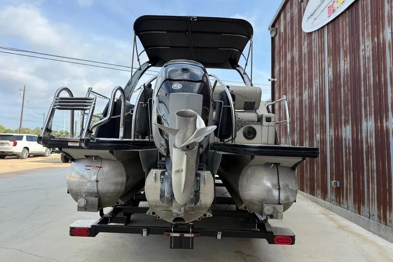 Slide: The Image of 2022 Barletta LUSSO 25UEA pontoon boat, rear view with motor and ladder. - 3
