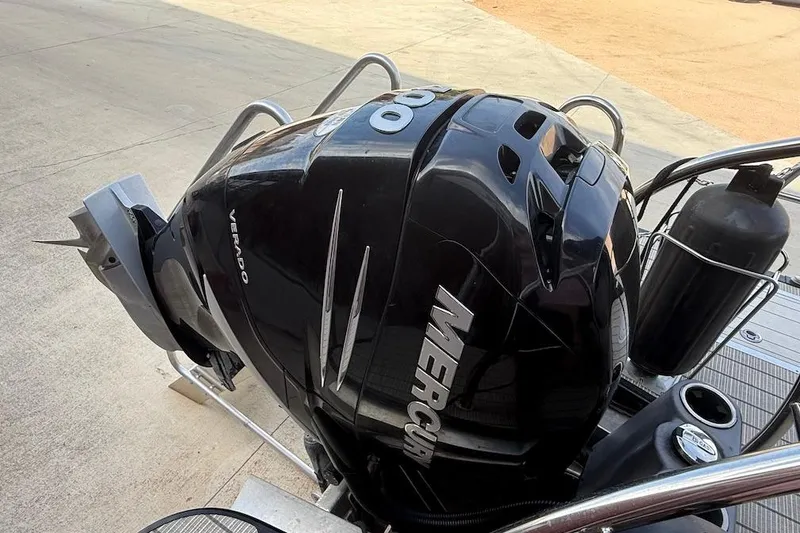 Slide: The Image of Mercury Verado outboard motor on 2022 Barletta LUSSO 25UEA boat, docked on concrete. - 4