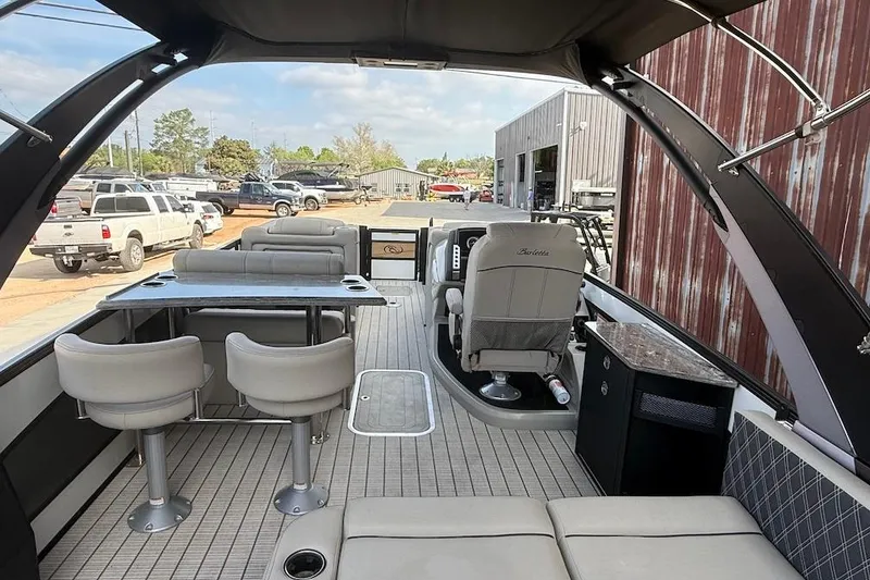 Slide: The Image of 2022 Barletta LUSSO 25UEA pontoon boat interior with seating and helm. - 6
