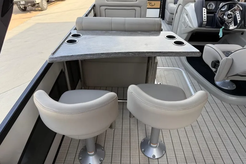 Slide: The Image of 2022 Barletta LUSSO 25UEA boat interior with seating and table setup. - 7