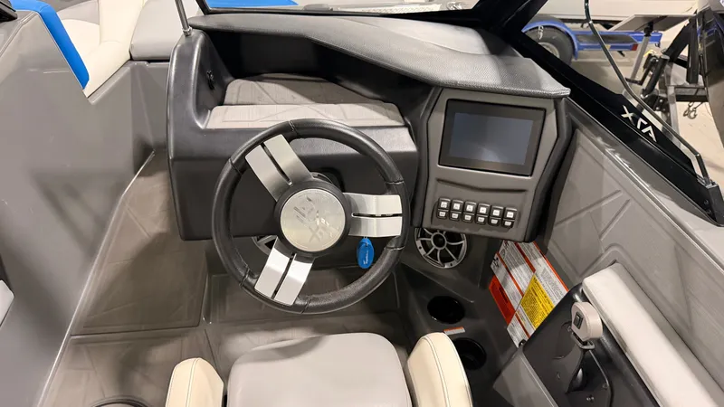 Slide: The Image of The image shows the cockpit of a 2020 ATX Surf Boats 22 Type-S with a modern steering wheel and digital display. - 23