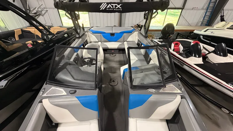 Slide: The Image of The image shows the interior of a 2020 ATX Surf Boats 22 Type-S. It features white and blue seating. - 39