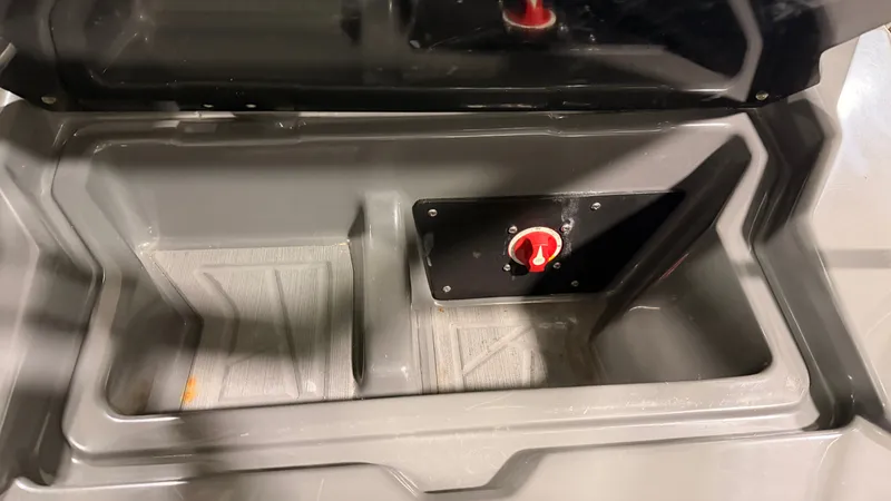 Slide: The Image of A gray storage compartment with a red dial inside a 2020 ATX Surf Boats 22 Type-S. - 29
