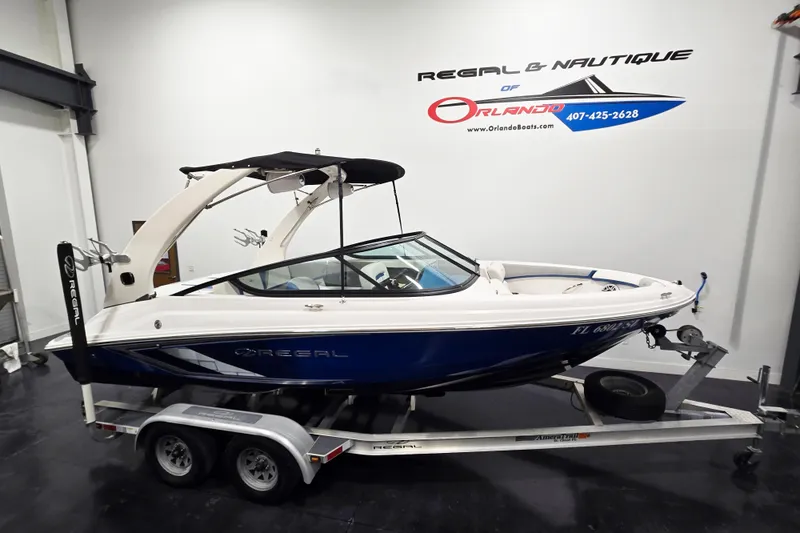 The Image of 2020 Regal 2000 ESX Bowrider on trailer in showroom, side view. - 1