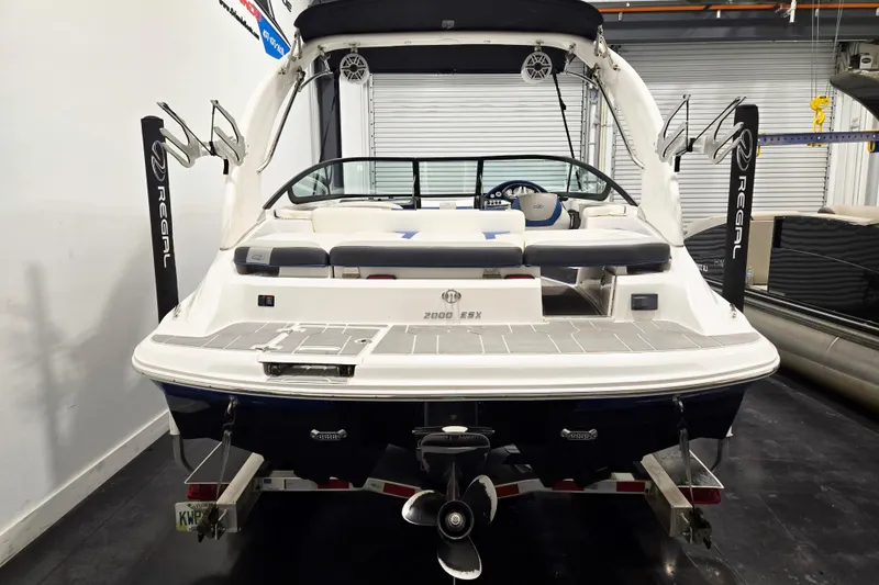 Slide: The Image of 2020 Regal 2000 ESX Bowrider boat in showroom, rear view with seating and propeller. - 4