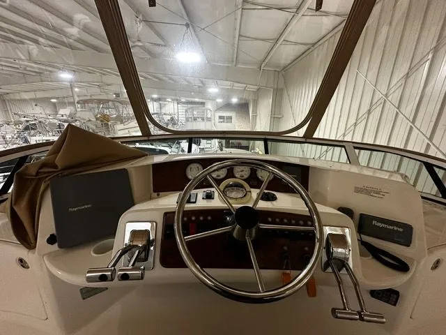 Slide: The Image of 2002 Silverton 39 Motor Yacht helm inside a storage facility. - 15