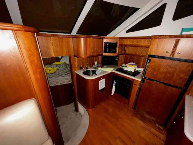 Slide: The Image of Interior of 2002 Silverton 39 Motor Yacht with kitchen and sleeping area. - 24