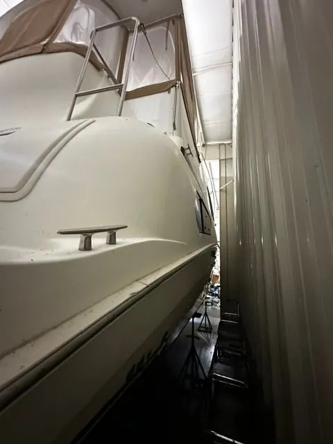 Slide: The Image of 2002 Silverton 39 Motor Yacht stored in a warehouse, side view. - 3