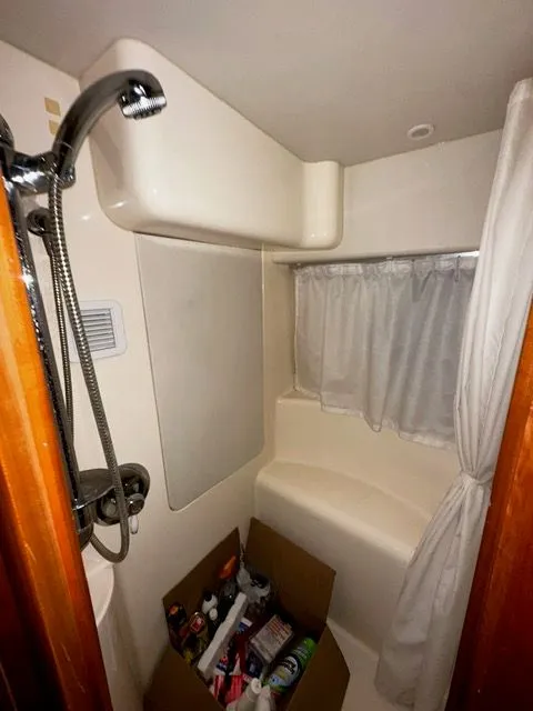 Slide: The Image of Bathroom of 2002 Silverton 39 Motor Yacht with shower and curtain. - 36