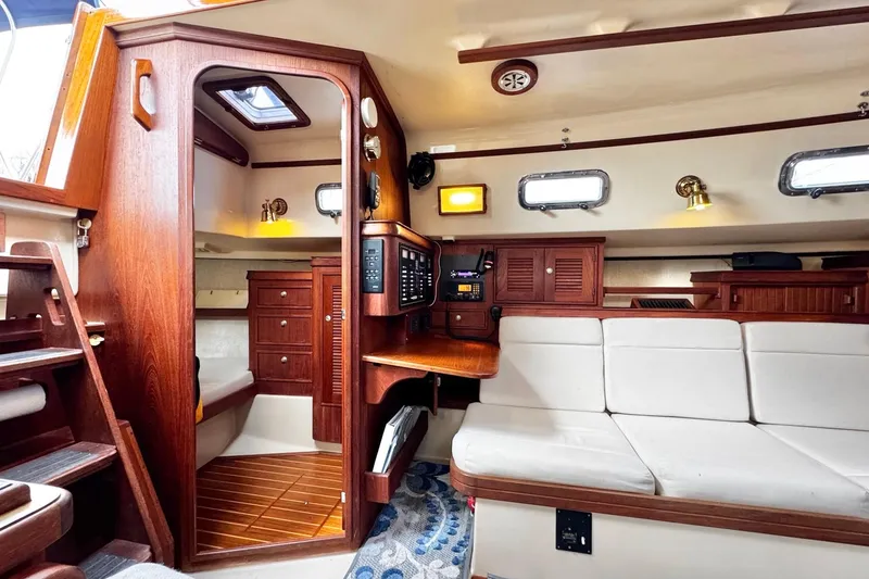 Slide: The Image of Interior of a 1998 Island Packet 350 sailboat with cozy seating and navigation area. - 15