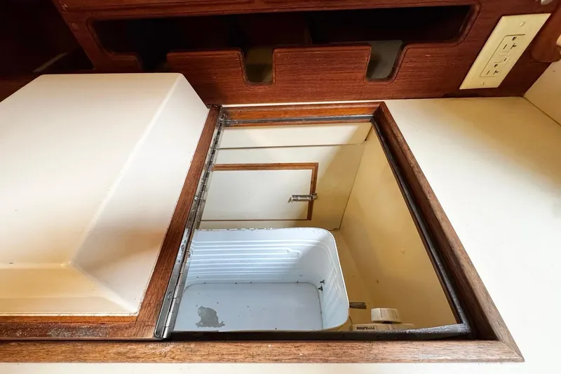 Slide: The Image of Interior of 1998 Island Packet 350 sailboat kitchen with stove, microwave, and wooden cabinetry. - 20