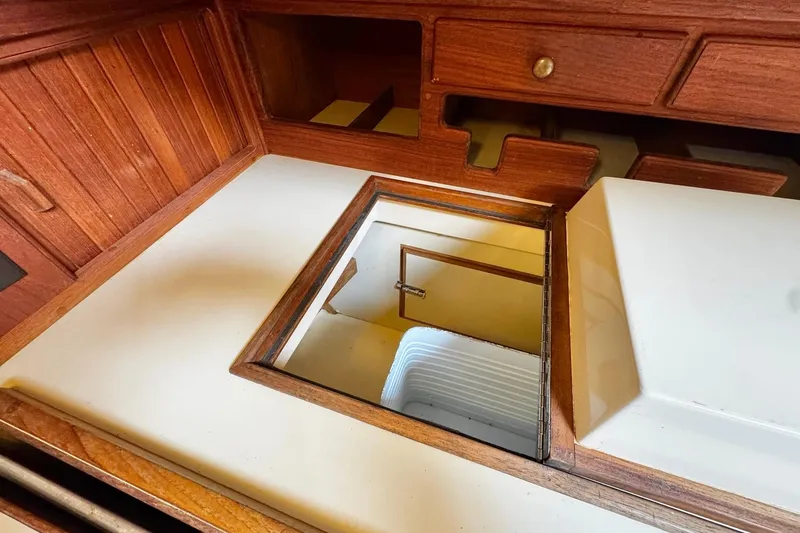 Slide: The Image of Interior of 1998 Island Packet 350 sailboat featuring a kitchen sink and microwave. - 21