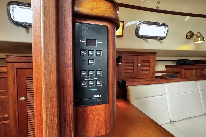 Slide: The Image of Interior of a 1998 Island Packet 350 sailboat featuring a compact kitchen area. - 27
