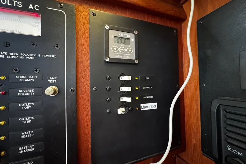 Slide: The Image of Electrical control panel of a 1998 Island Packet 350 yacht, featuring AC and DC systems. - 30