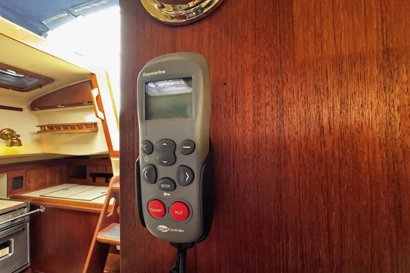Slide: The Image of Electrical control panel on a 1998 Island Packet 350 sailboat, featuring battery monitor and switches. - 32