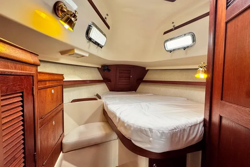 Slide: The Image of Raymarine controller on 1998 Island Packet 350 yacht interior, wooden panel background. - 34