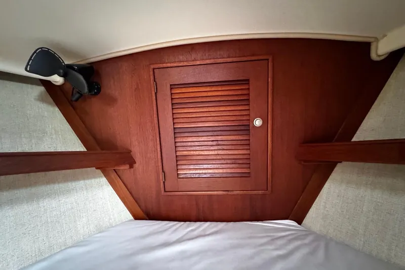 Slide: The Image of Cozy cabin interior of 1998 Island Packet 350 sailboat with porthole and reading light. - 38