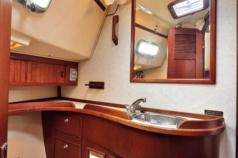 Slide: The Image of Cozy cabin interior of 1998 Island Packet 350 sailboat with wooden furnishings. - 39