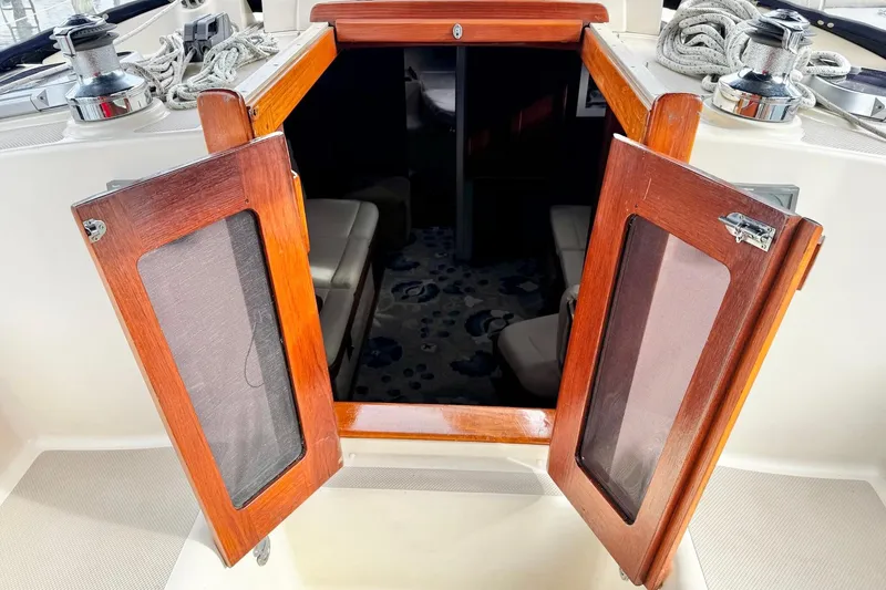 Slide: The Image of 1998 Island Packet 350 sailboat "Spirit Bear" docked in a serene marina setting. - 4