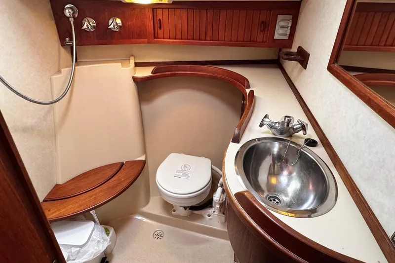 Slide: The Image of Interior cabin of 1998 Island Packet 350 sailboat with wooden paneling and storage compartment. - 40