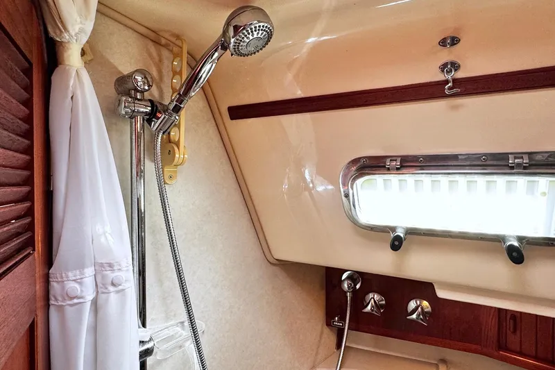 Slide: The Image of Interior of 1998 Island Packet 350 sailboat bathroom with wooden cabinetry and sink. - 41