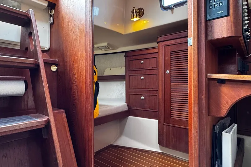 Slide: The Image of 1998 Island Packet 350 yacht bathroom with wooden accents and stainless steel sink. - 42