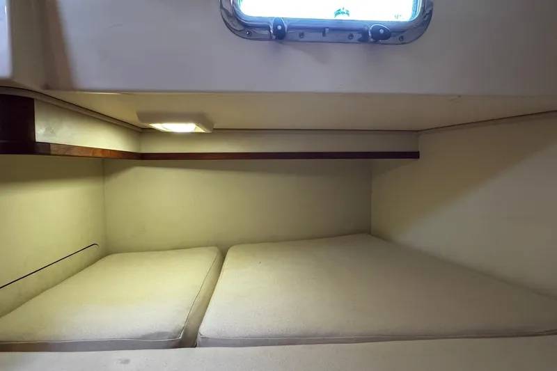 Slide: The Image of 1998 Island Packet 350 interior with wooden cabinetry and drawers. - 45