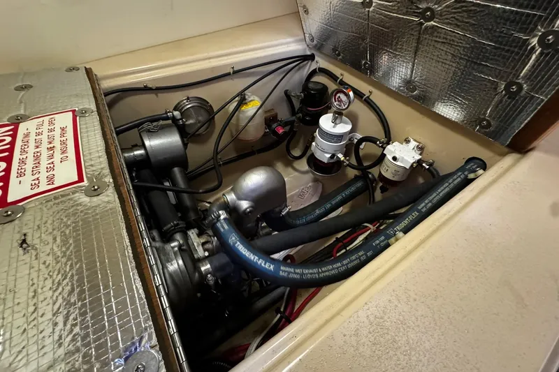 Slide: The Image of Interior of 1998 Island Packet 350 sailboat with cozy seating and fire safety equipment. - 48