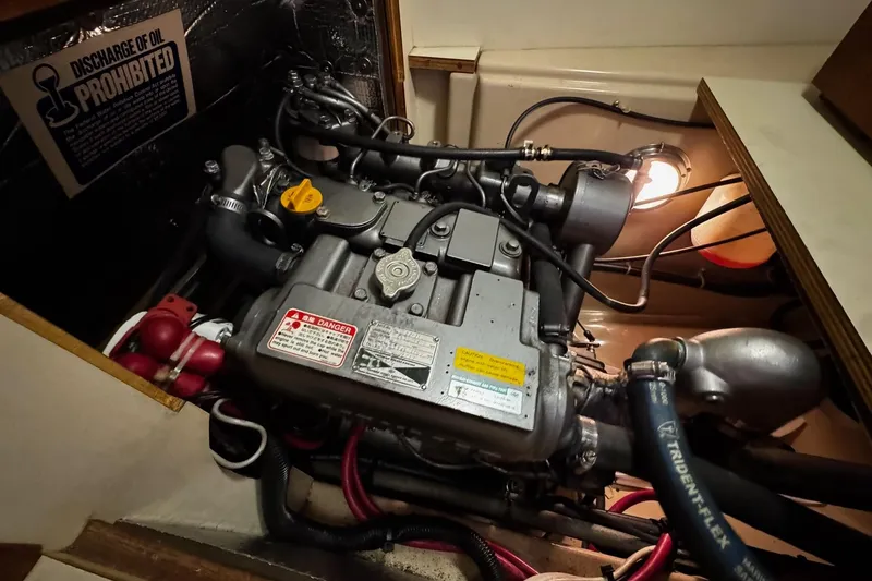 Slide: The Image of Engine compartment of a 1998 Island Packet 350 sailboat, showing hoses and components. - 50