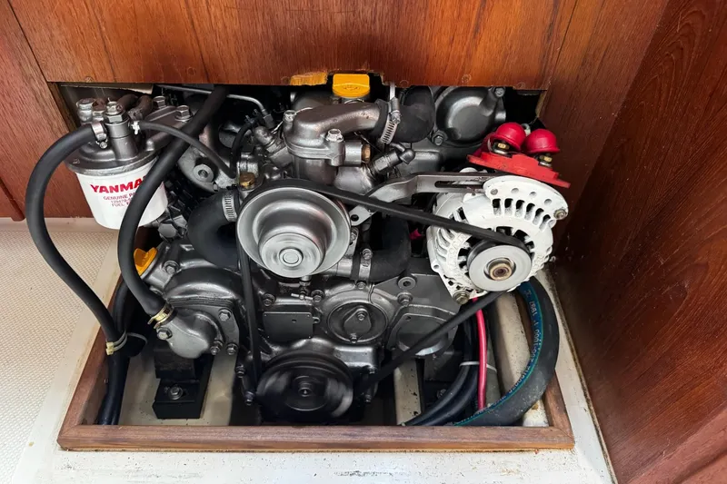 Slide: The Image of Engine compartment of a 1998 Island Packet 350 sailboat, featuring detailed mechanical components. - 52