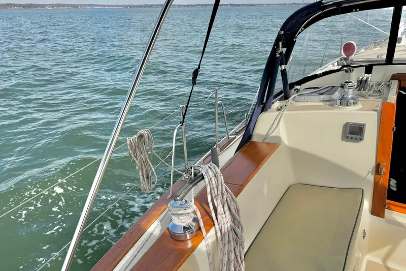 Slide: The Image of Engine compartment of a 1998 Island Packet 350 sailboat, featuring a Yanmar engine. - 54