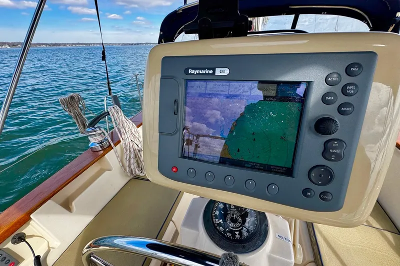Slide: The Image of Cockpit view of a 1998 Island Packet 350 sailboat with ocean backdrop. - 58