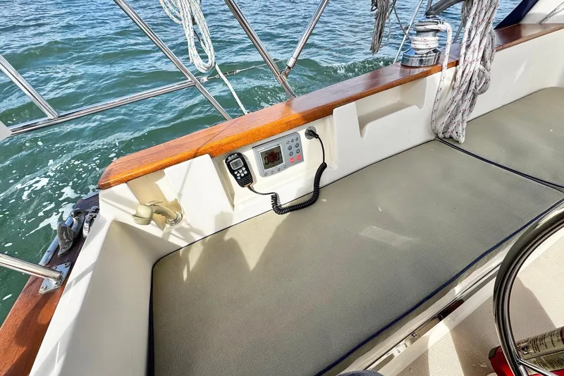 Slide: The Image of Compass on 1998 Island Packet 350 sailboat, with beige seating and nautical ropes. - 61