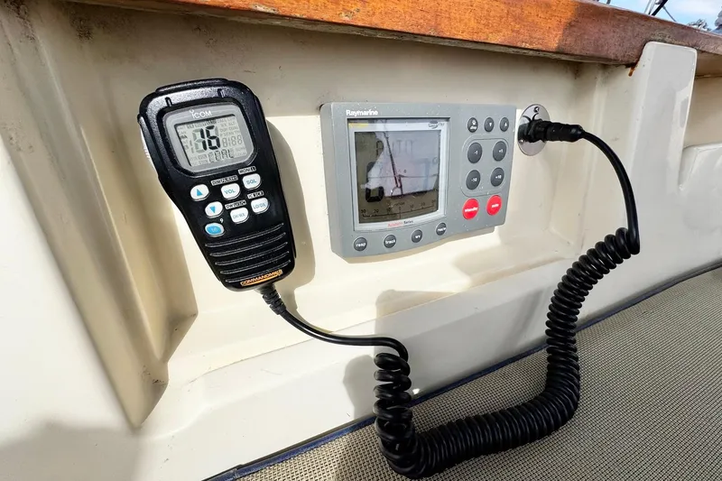 Slide: The Image of 1998 Island Packet 350 sailboat cockpit with steering wheel and navigation instruments. - 62