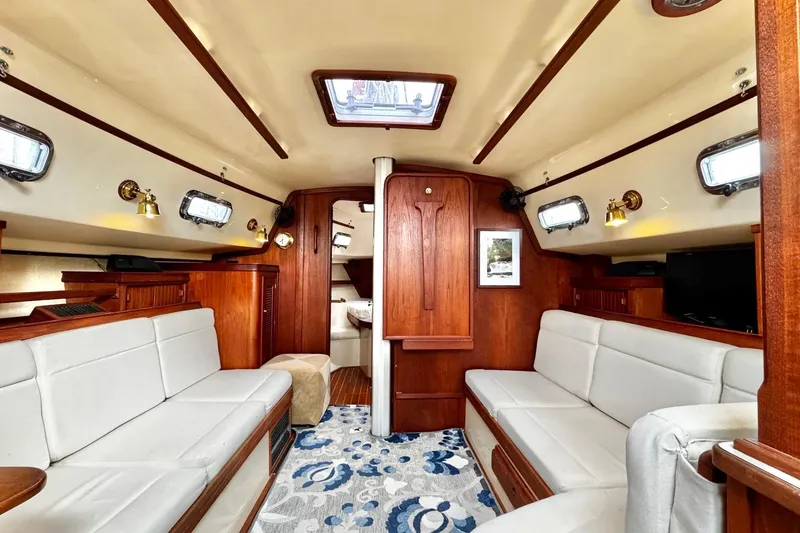 Slide: The Image of Interior of 1998 Island Packet 350 sailboat with wood finish and cozy seating. - 7