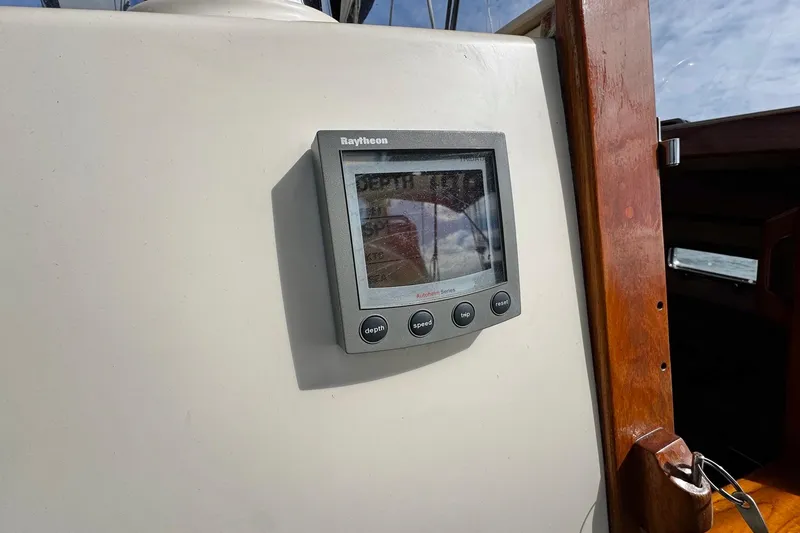 Slide: The Image of Cockpit of 1998 Island Packet 350 sailboat with steering wheel and navigation instruments. - 71