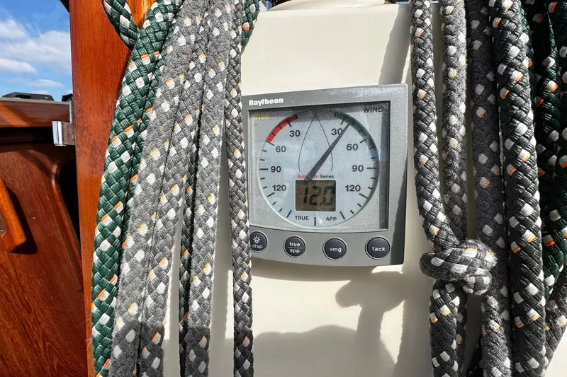 Slide: The Image of Cockpit of 1998 Island Packet 350 sailboat with cushioned seating and navigation equipment. - 72