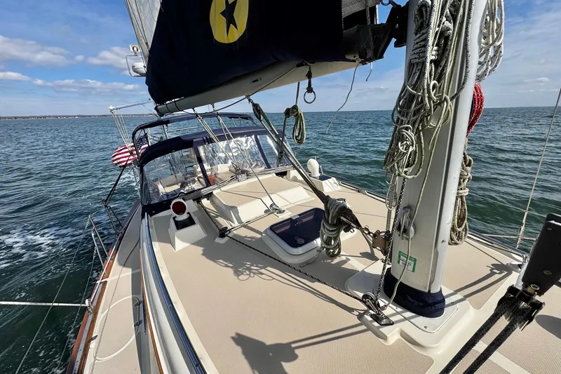 Slide: The Image of Bow of 1998 Island Packet 350 sailboat on open water, showcasing deck and rigging. - 90