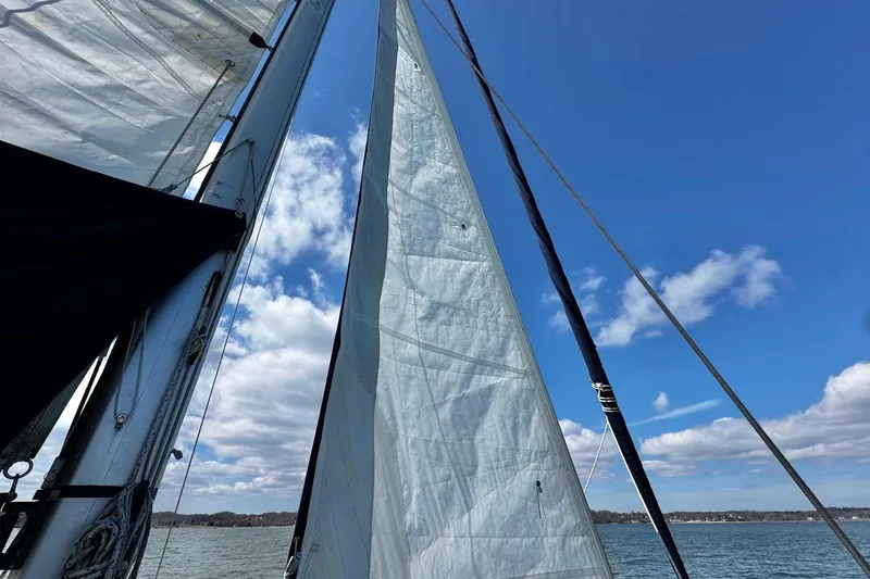 Slide: The Image of Sailing on a 1998 Island Packet 350 yacht with clear skies and calm waters. - 96