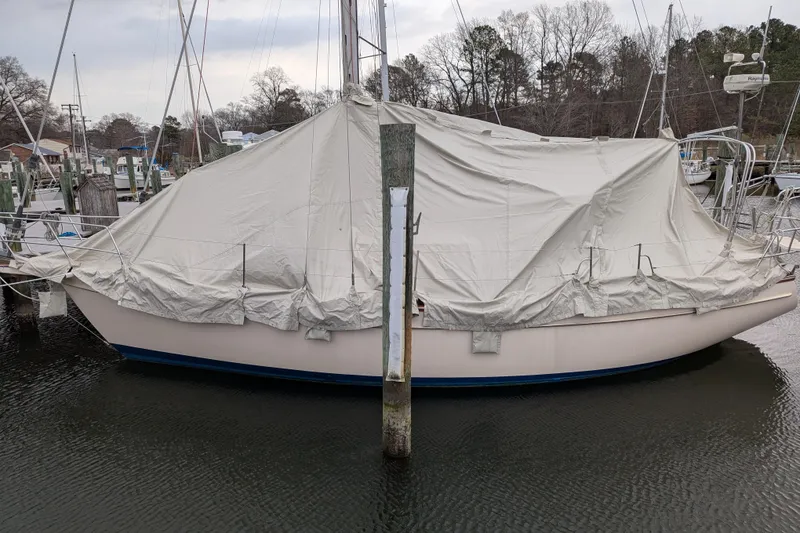 Slide: The Image of 1998 Island Packet 350 sailboat covered with tarp in marina. - 98