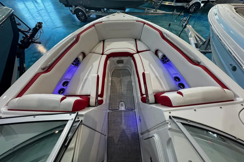Slide: The Image of 2024 Crownline 250 XSS boat interior with red and white seating, blue LED lighting. - 5